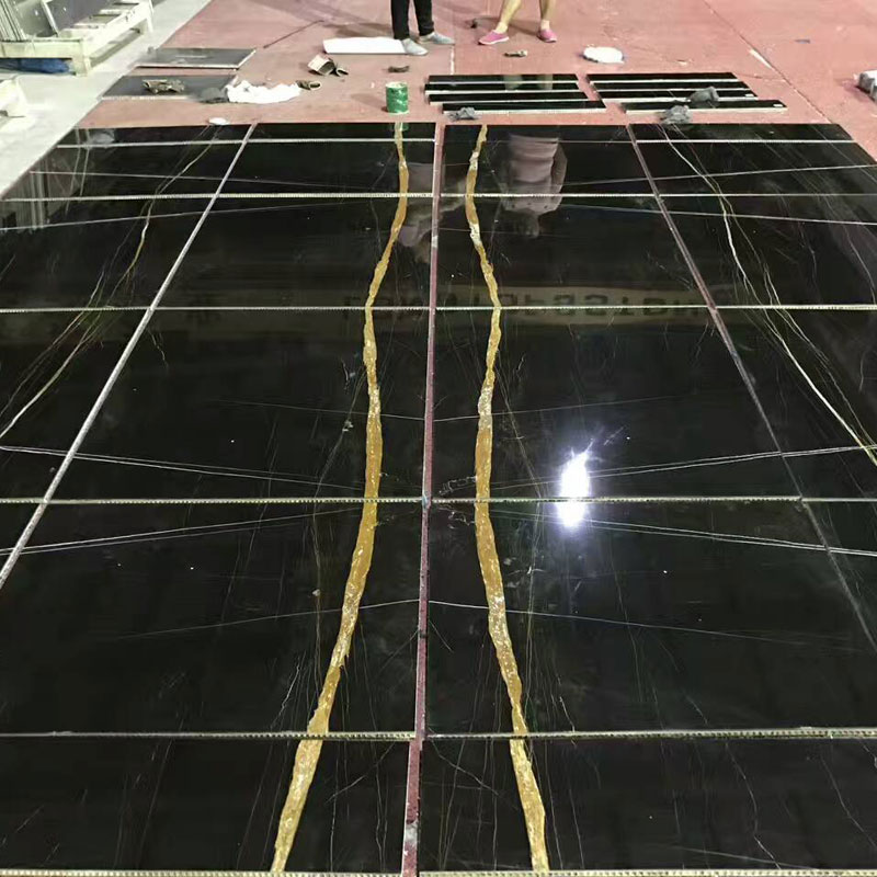 Nero Dorato Marble bookmatched feature wall